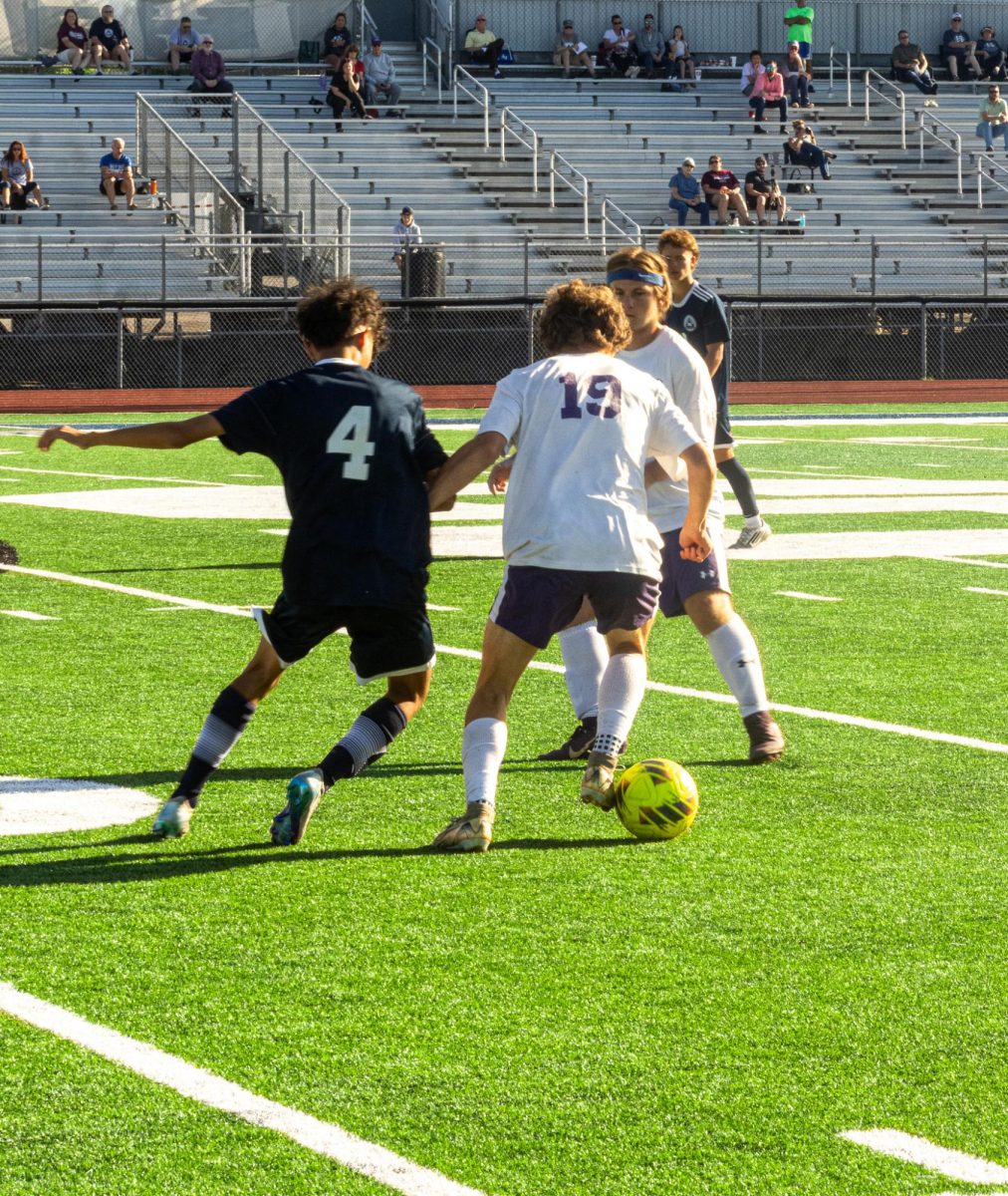 Sophomore Nathan McGowan battles through the Cadet offense. He kept control of the ball as he pushed the ball upfield. 