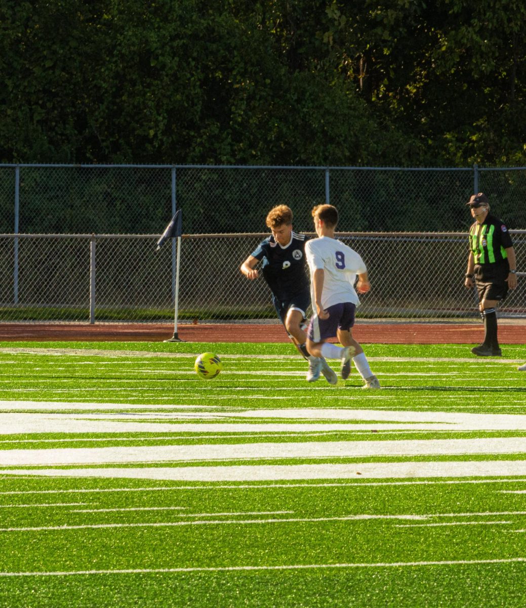Center midfielder Kyle Goughenor races downfield staying poised under pressure. As he plays the ball to his offense for a chance to score.