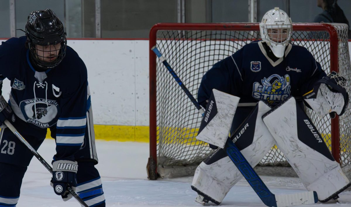 Standing in the ready position, senior Carson Giddens and junior William Hackmann get ready for the puck. Puck drop is a key moment for the defense.
