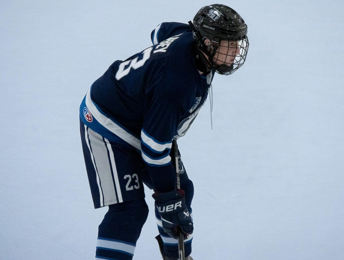 Watching carefully for the puck, senior Dimitry Babey looks for opportunities to score. Hockey players have to always have an eye out for ways to get a goal.
