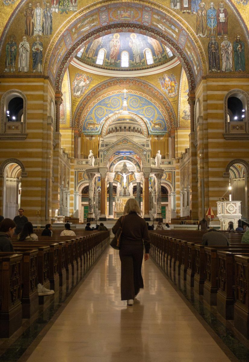 As her students sit and admire the Basilica during the AP Art History field trip on Nov. 17 to the St Louis Basilica, Mrs. Michelle McCune walks down the aisle. She admires the altar she's seen every year with her students for its extraordinary beauty, as she begins to collect her students to head back to the school.
