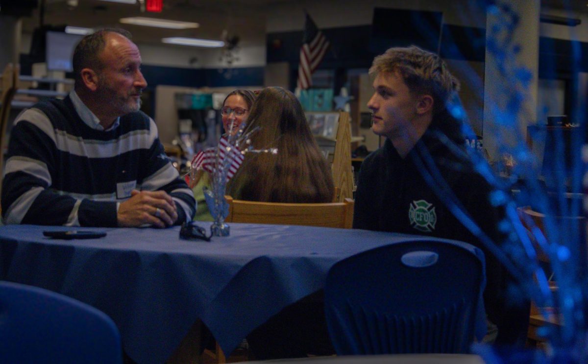 In a moment of silence on Nov. 12, freshman Greyson Engels and his veteran William Engels, look at each other intently. Engels’s father served 6 years in the army serving our country. 