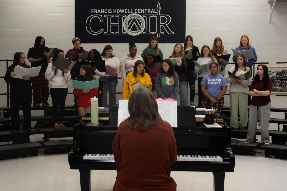Choir teacher Donna Solverud plays piano on Nov. 17 as the choir sings in front of her. While the choir learns their songs, Solverud plays the accompaniment, but at the concert she directs the choir and brings in accompanists. 
