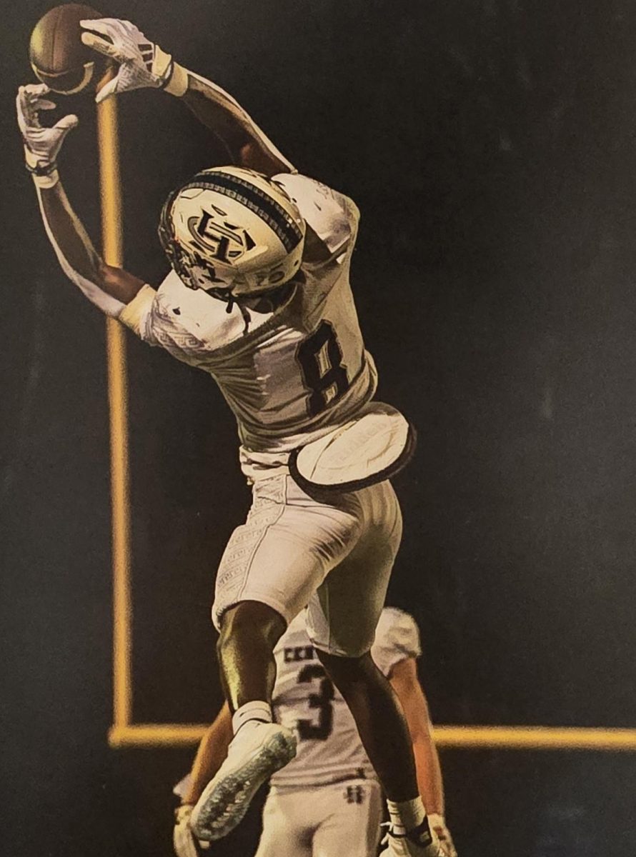 Senior Don Thornton reaches for the ball at a football game showing his athleticism to college coaches. While having just one goal in mind to succeed, he learns through his mistakes as he scores a touchdown. 