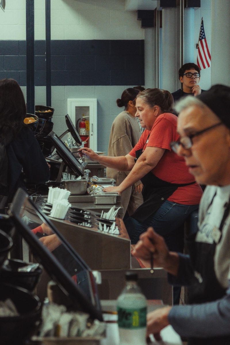 Sitting in the middle, Kim Moron puts in orders during the 5b lunch rush on Nov. 5. It's important for them to stay focused during this time as this is one of the busiest spots during lunch.

