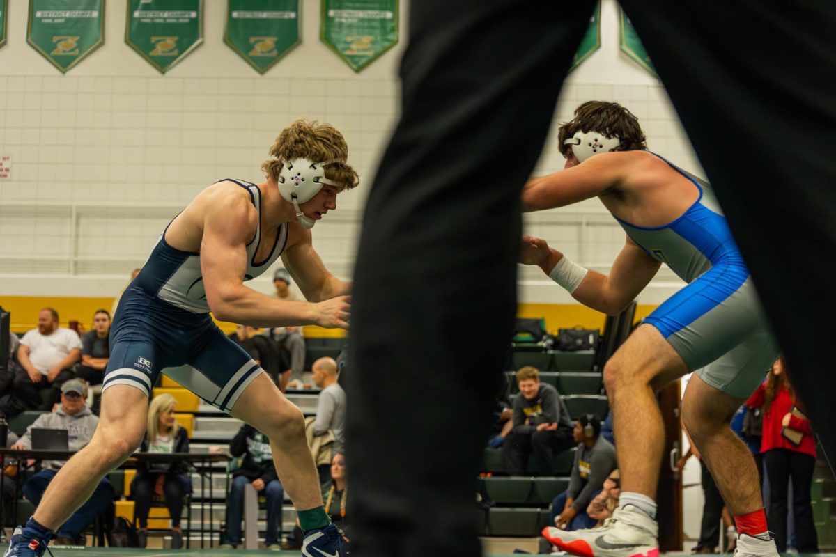  Junior Sam Golden looks for a shot to get a take down on Dec. 6 and get his three points. Golden hand fights with the Seckman wrestler until he can work in for a shot. 
