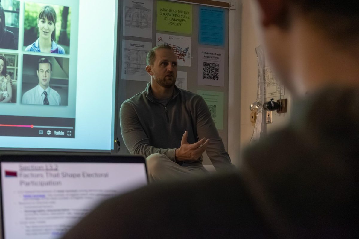History teacher Nick Beckmann teaching his AP Government classroom. This advanced class has been used to inform students about the country's past and current political status.