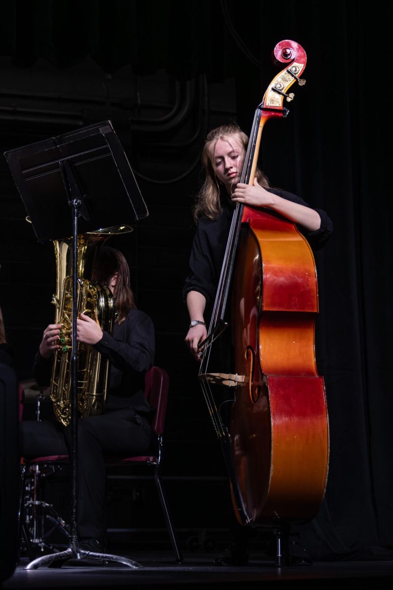 Senior Marissa Crandall playing base on Dec. 9. Crandall was focused, ensuring to play the right notes during the concert. 
