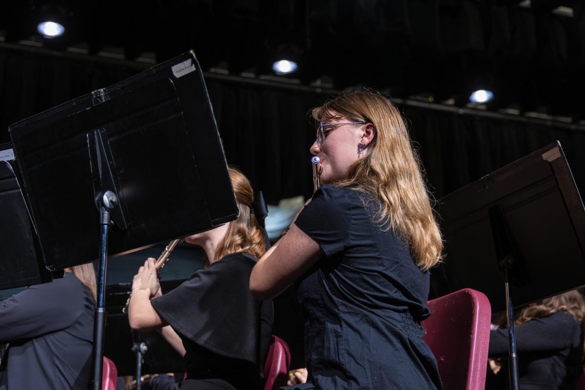 paying the flute junior Anna Tilly reads her sheet music making sure to stay on beat on Dec. 9. This was imperative since she performed a solo. 
