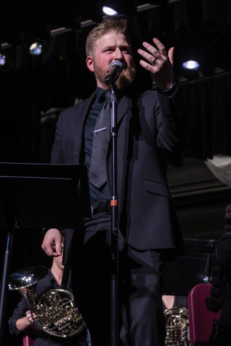 On Dec. 9, band director, Mr. Steck, talks to the crowd before performing the last song of the night. For their last song, wind ensemble played “Sleigh Ride”.