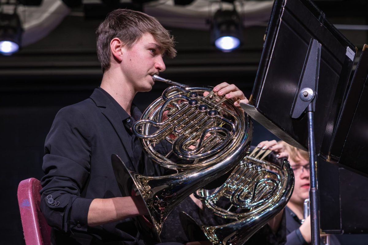 As he reads his music, junior Chris Allen plays the french horn on Dec. 9. He tried to stay on pace with with the band director Mr.Steck

