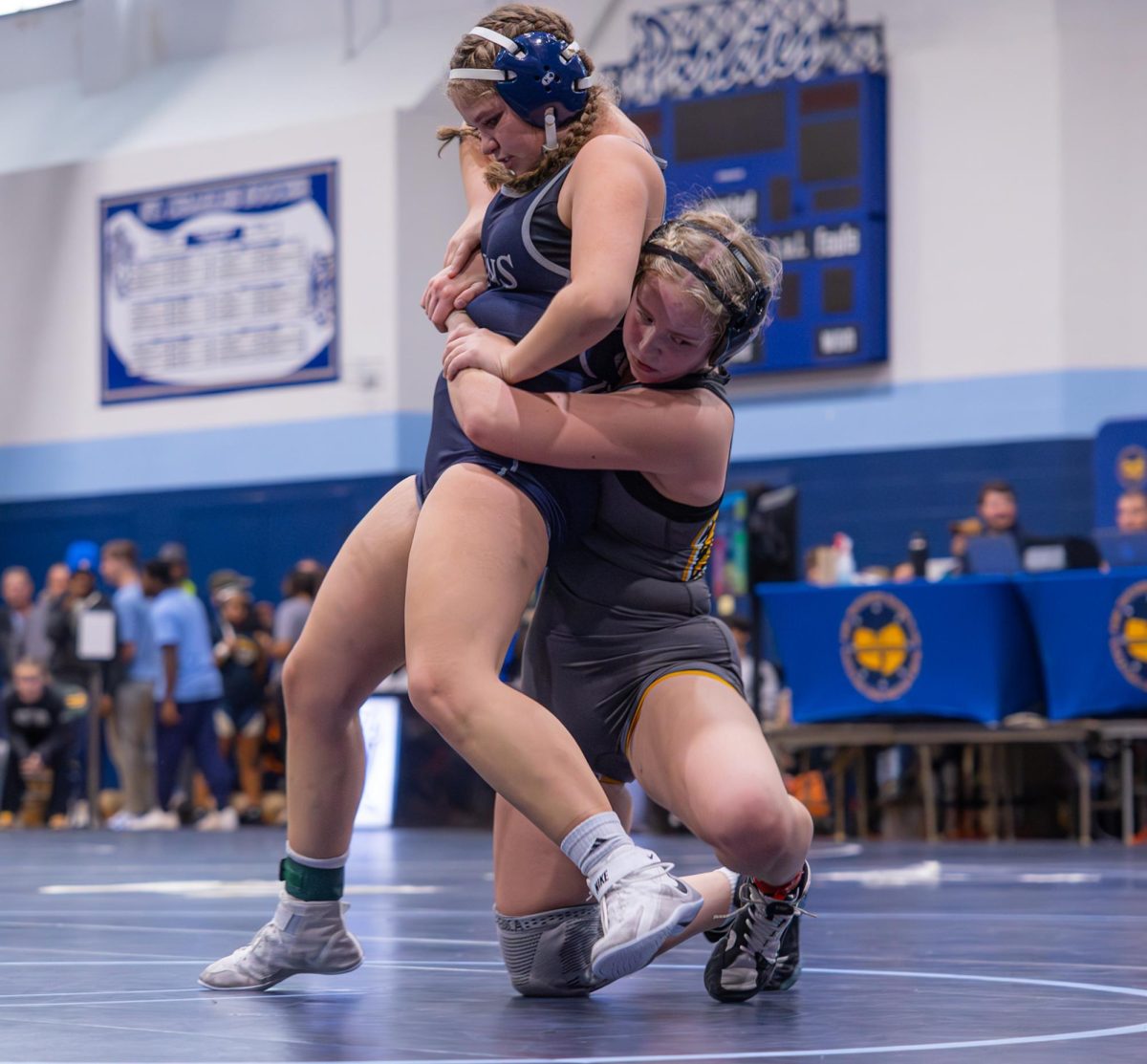 Freshman Tiana Beach stands up to get a point for an escape on Nov. 22, she uses pure strength to remove the arm from around her waist that is keeping her from leaving. Her opponent continued to slam Beach to the mat, but was unable to keep her down for long.