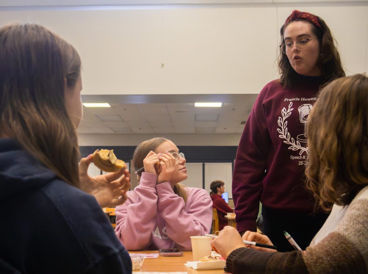Junior Hannah Figura and senior Addie Law talk at the Epsilon Beta meeting on Nov. 19. Figura grabbed Law’s attention after talking with her friends