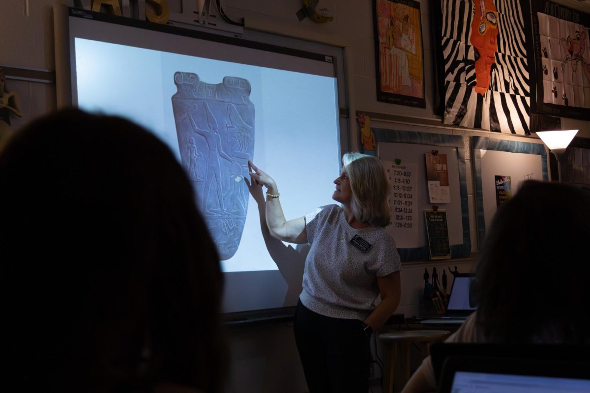 AP Art History teacher Mrs. Michelle McCune points to a commonly featured work: the Palette of King Narmer. After students have taken notes over the assigned pieces, McCune lectures in order to tie all of the information together. 