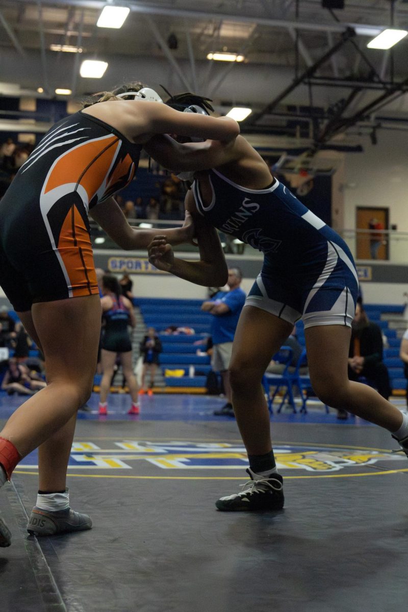  As the match begins to get more intense, Maliya Davis is fighting for points on Dec. 12. The match is heated, and both wrestlers are fighting to win.
