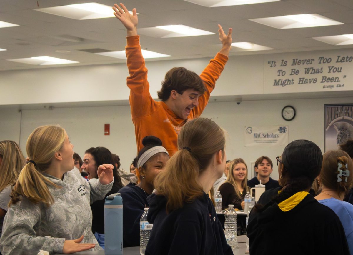 On Nov. 21 at the Arete breakfast senior Braden Harton jumps in exhilaration when his ticket number is read. Harton was eagerly waiting as each winning number was being delivered.