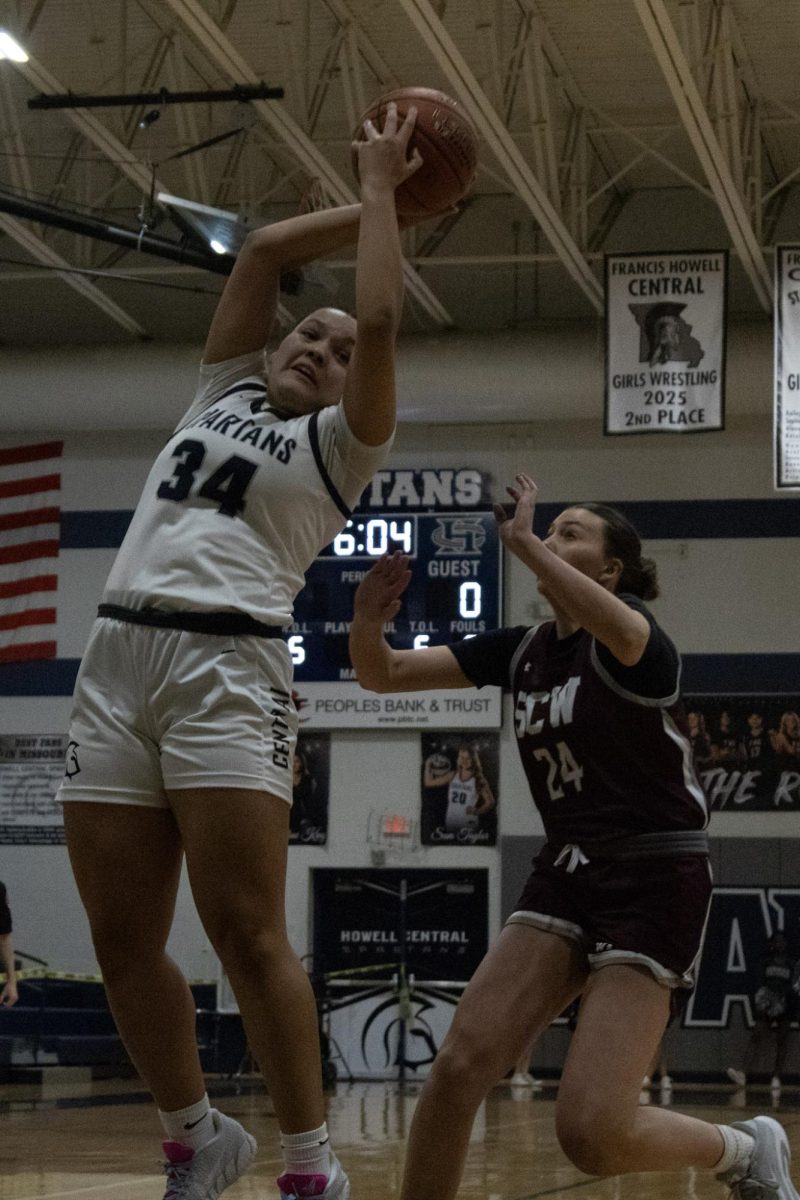 Freshman Nora Allen jumps off the ground in order to prevent a pass from going out of bounds on Jan 20. She reached her hands around the ball, cutting off its motion, and when she landed she took the ball toward the basket for a shot.