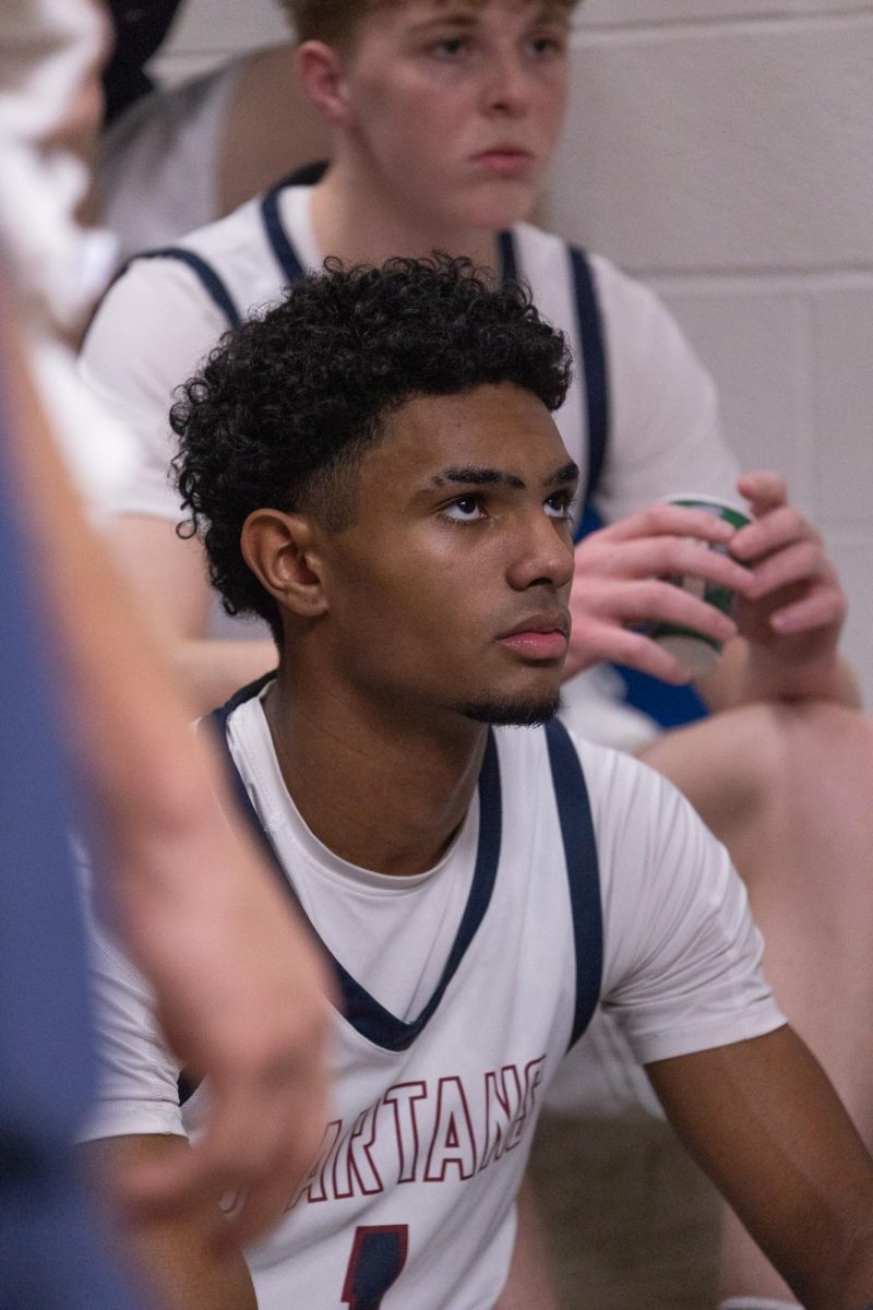 Looking up at his coach during half time, senior Xavier Morrison makes sure to take in all the information he says. Half time is used as a way to reset the players and for coaches to give feedback. 
