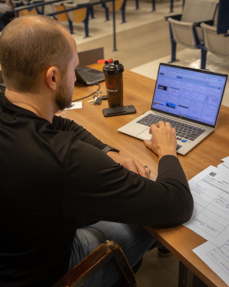 In study hall Nick Beckman looks over his students screens to ensure they are on task.
