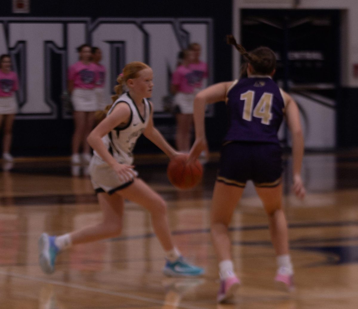 Freshman Chloe Bond dribbles the ball past an opposing player and down the court. She bounces the ball while thinking of her next move on Jan. 9.

