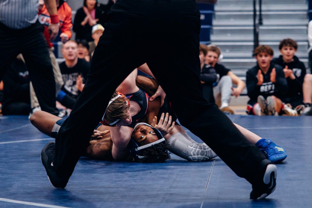 Pinned on his back, freshman Dorian Watson tries to gain leverage on Jan. 7. The ref watched to ensure there was no foul play.
