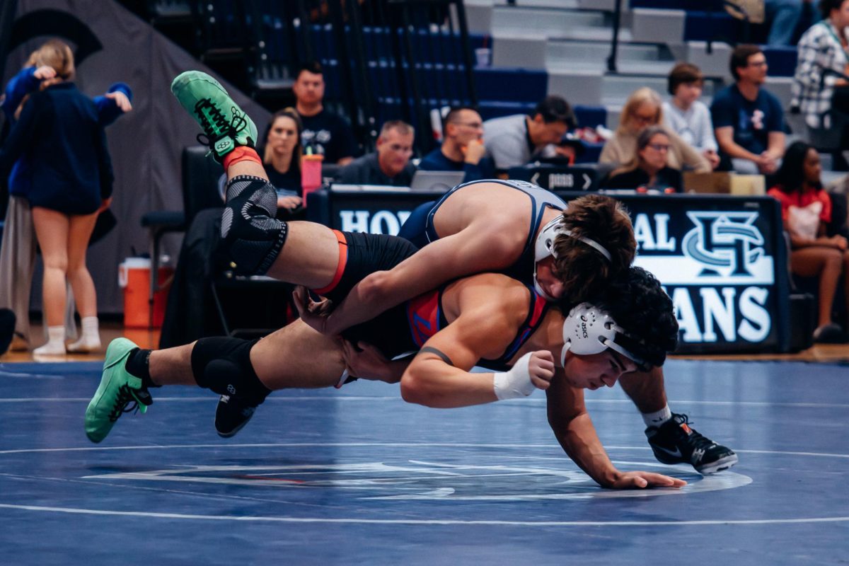 Junior Owen Eisworth is mid air while slamming down his opponent on the mat on Jan. 7. Eisworth was able to pin his opponent giving Central the point.