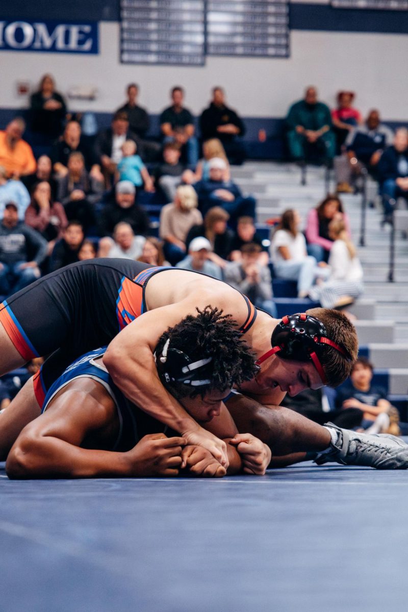 On the mat, sophomore Kareem Perkins gets pinned by Liberty. Perkins lost the point for the match but Liberty lost the meet with a 36-35 ending score.