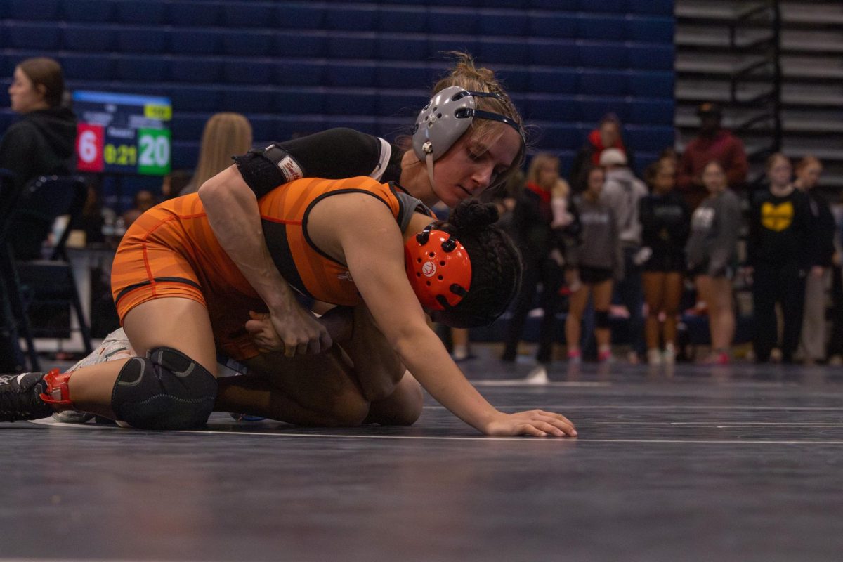 On Jan. 17, Addison Holtgrewe wraps her arms around her opponent while trying to flip her over. The game ends with Addison winning with a strong hold.