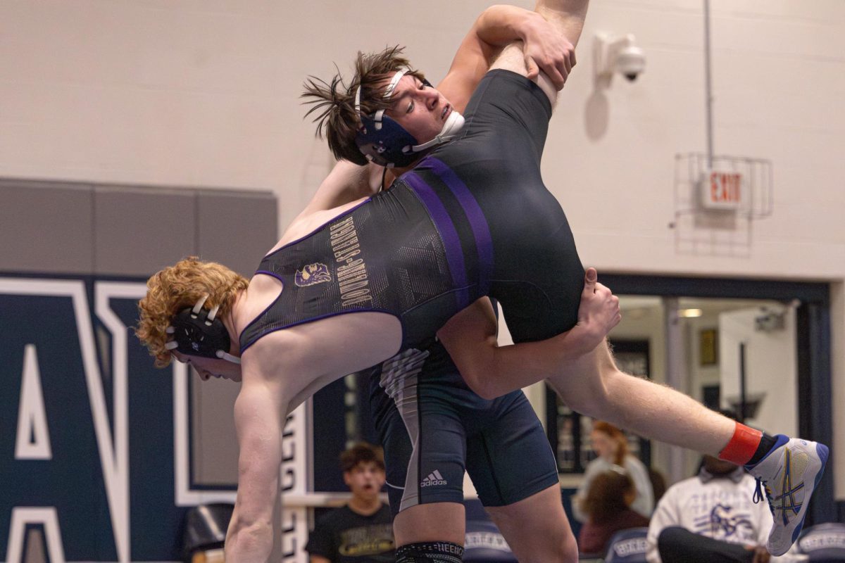 Freshman Seth Nichols slams his opponent to the ground, as Troy’s wrestler puts his arm straight down as an attempt to brace himself. Nichols’ initial move on Jan. 21 to get to this lift was hitting a double leg shot, and then using that momentum to take the athlete over his shoulder.