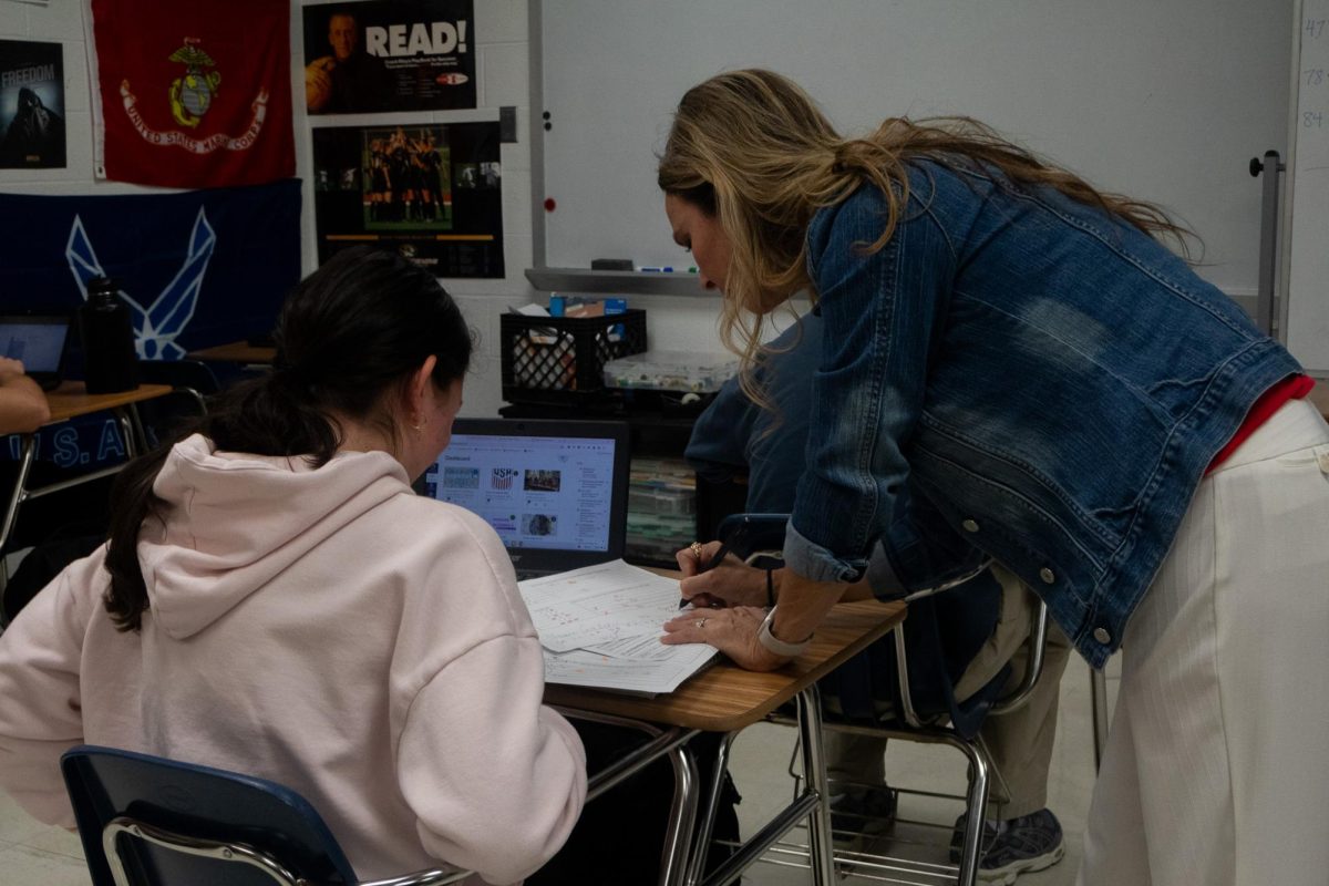 Laurie Fay goes over a student's work with her. Fay maintains a staunch disposition towards cheating through the various methods by which it occurs.