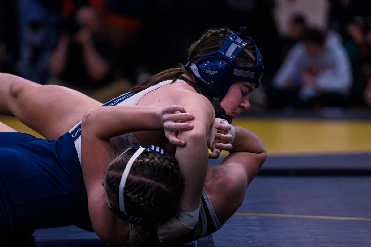 Kaitlyn Sparkman pins her opponent in her second bout of the day on Feb. 13. Sparkman is balancing club soccer and school wrestling while maintaining a high GPA, finishing the tournament first in her weight class.
