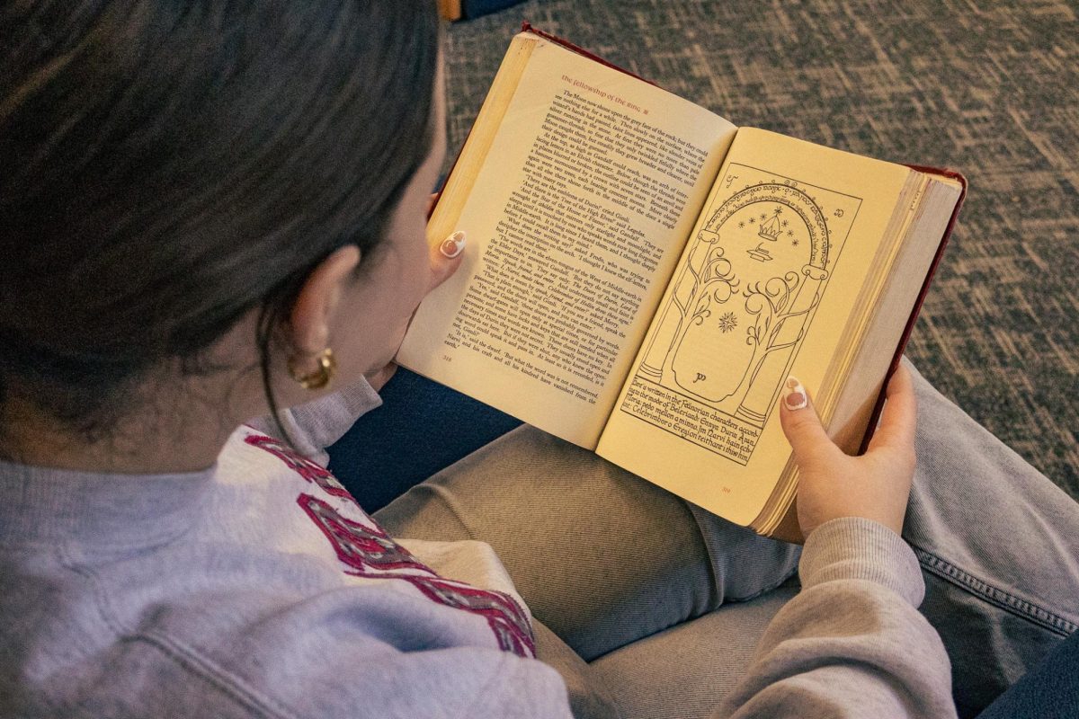 Senior Sophia Poenicke reads The Fellowship of the Ring by J.R.R. Tolkien in the learning commons. The Lord of the Rings series is often regarded as the gold standard of fantasy.