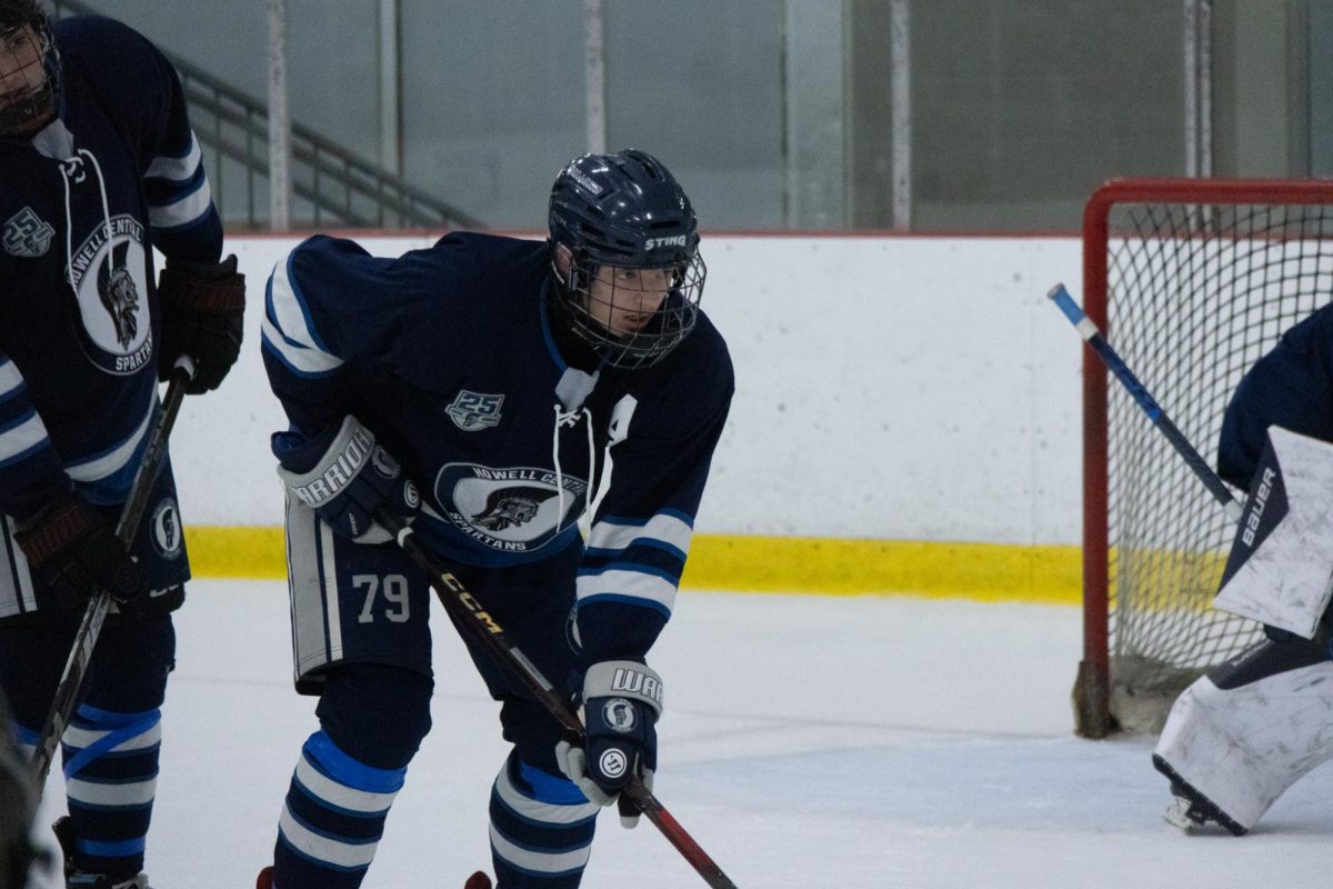 Carson Bextumueller waiting with intensity as the puck is about to get dropped during a face off. As a hockey player, Bextumueller has seen the movie "Miracle," based on the 1980 Miracle on Ice Olympic hockey team, numerous times.