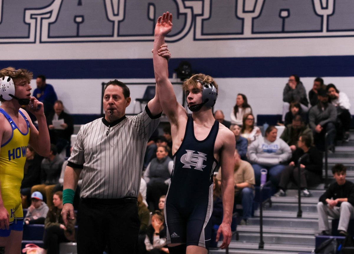 After winning his match on Jan. 14, the referee raises freshman David Bundy’s hand to declare he was the winner. Bundy had one match, allowing him to win all his matches that day.