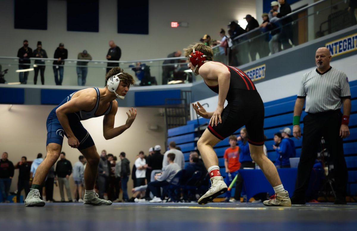 Two opposing wrestlers facing each other before a match. Students can be quick to pick a side based on friends or other external factors with-out conscious thought of the opposite team.