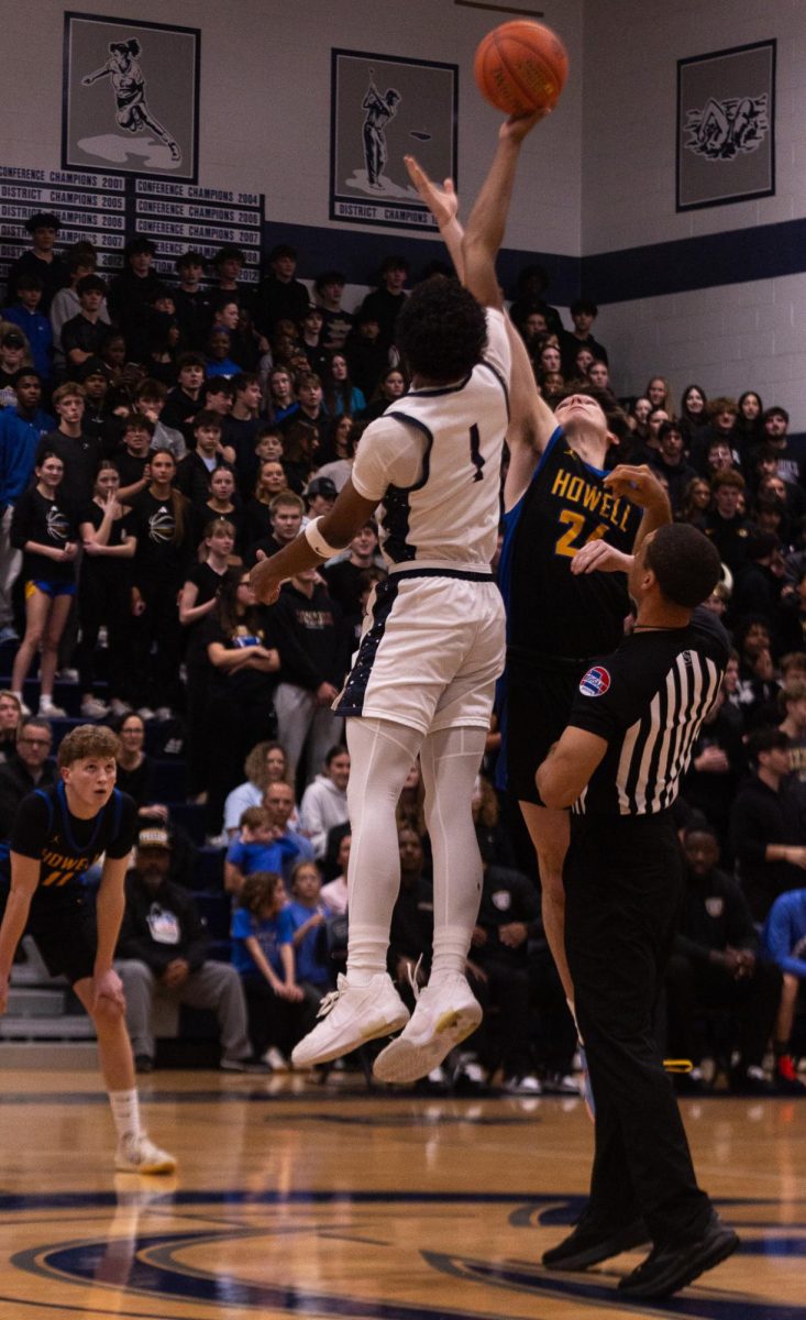 Senior Xavier Morrison leaps for the jump ball to start the game against Howell on Feb. 20.
Morrison won the ball for the Spartans who drive down court.
