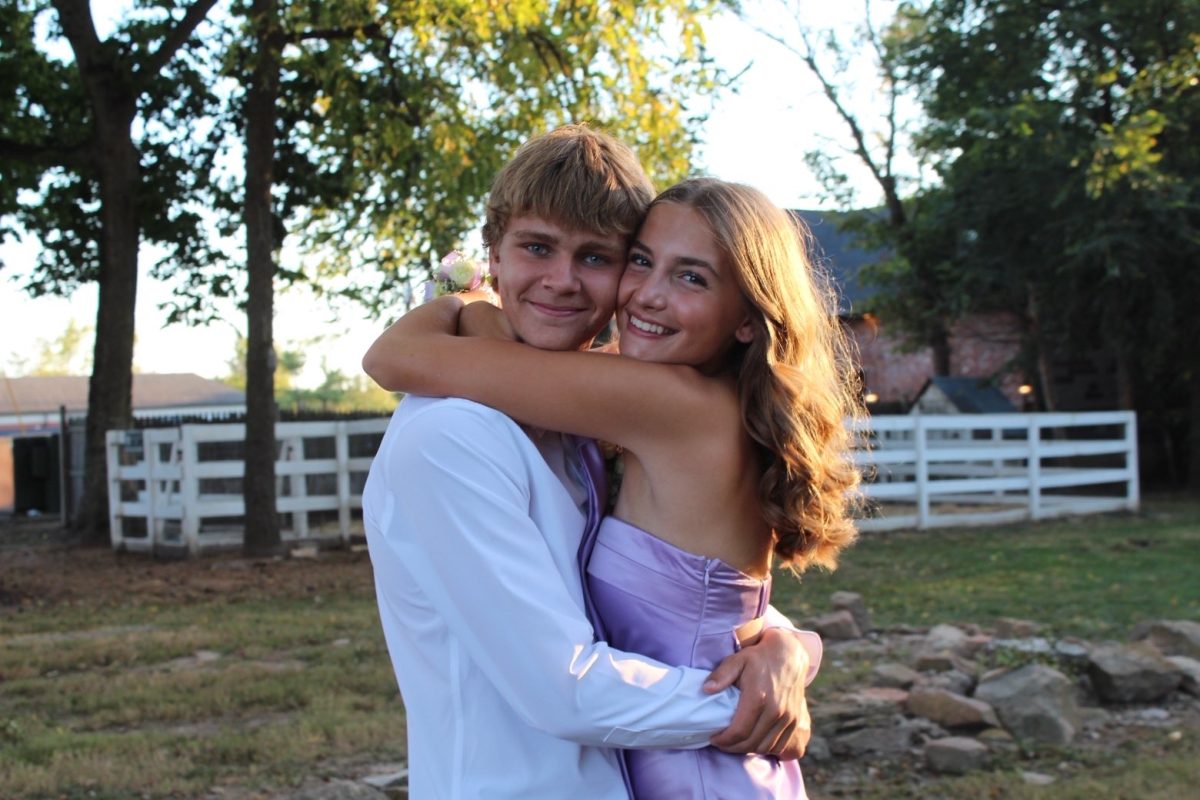 Timm and Wiehage happily pose for a homecoming picture. Although they are dating, they are also best friends.