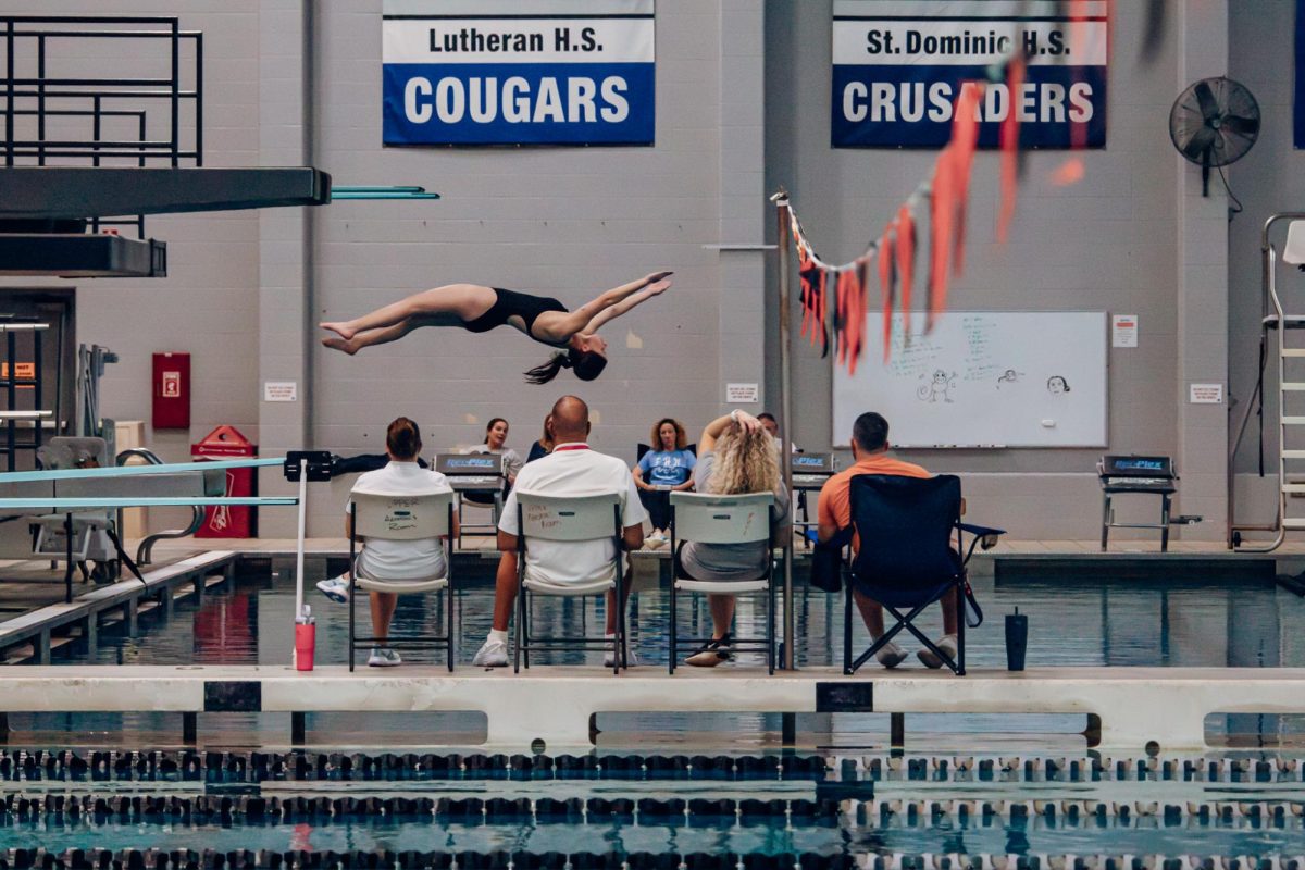 The judges watch as Audrey McCann performs a backwards dive on Feb. 5. McCann ended GACs in first place.