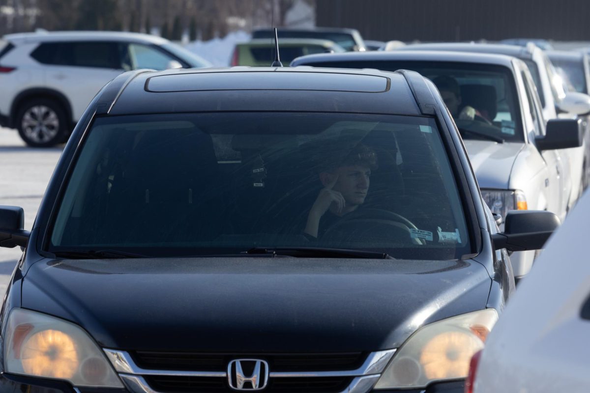 Junior Dominic Hartwell gets frustrated while trying to leave the student parking lot. At the end of the day a long line slowly exits the campus. 