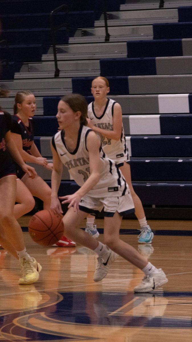  Freshman Adrienne Winter darts down the court on Feb. 17, dodging the opposing players. She moves quickly on her feet making sure not to trip up or make any mistakes.