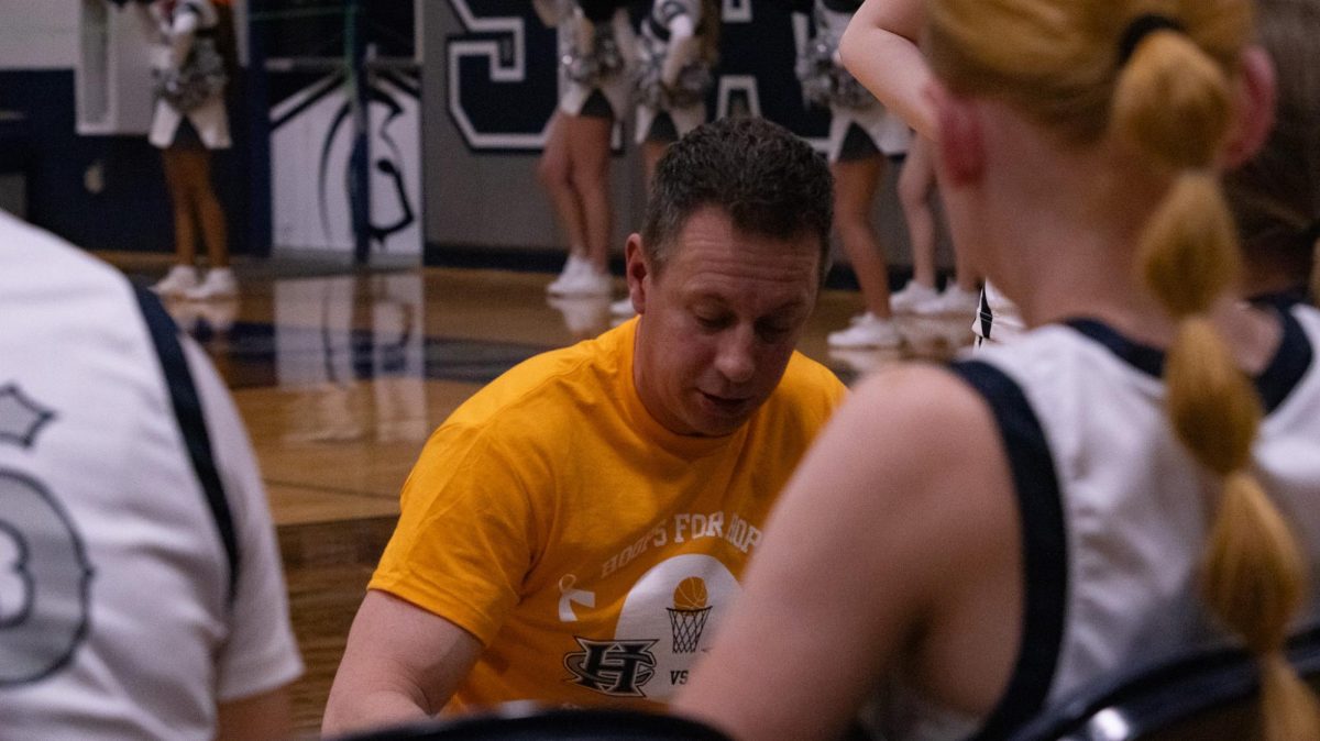 During a time out on Feb. 17, coach Corey Winters  talks to the girls about plays they can make and moves to keep the game going. The coach keeps the girl's spirits high in tough moments.