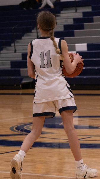 Standing at the end of the court freshman Adrienne Winters watches the liberty players surround her and her teammates. She looks around for a teammate to pass the ball to on Feb. 17.