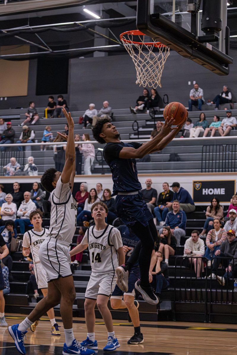 Senior Xavier Morrison goes for a layup on Mar. 27. Morrison often goes for difficult layups using his size and power to push through defenders into the paint.
