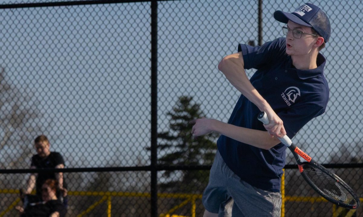 Guarding the backside of the court, Carson Schafermeyer returns the tennis ball with a forehand that won them the game. The final score between the two teams on that court was 6-3.