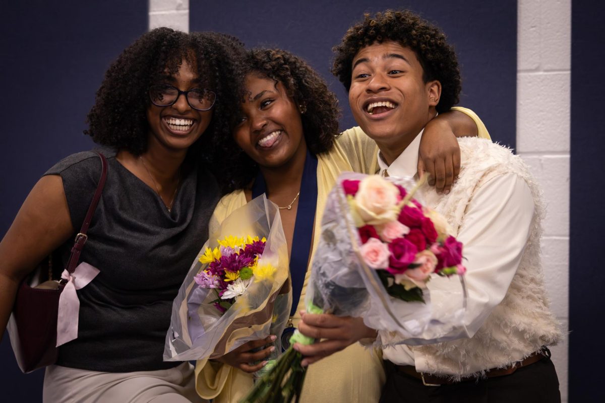 Posing for a picture on Feb.26, senior Nuwelin Dagne, Liya Fikru, and junior Jacob Banks begin to laugh. Fikru received a Silver Shield from Ms. Moore.
