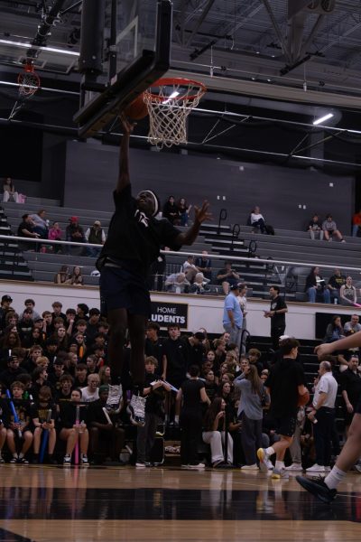 With precision and using all his strength on Feb. 27, at the basketball game against FHN. Senior Jakari Reddin ran up to the basketball hoop as he attempted to make a hoop.