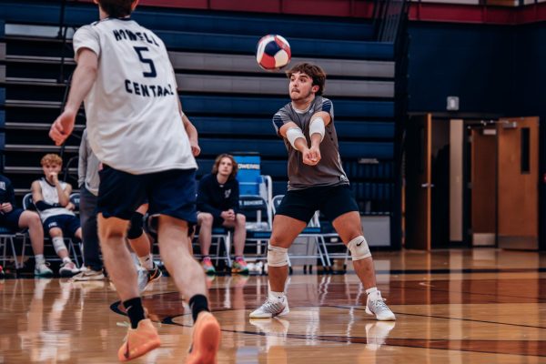 Senior libero Bradon Harton bumps a ball from St. Dominic,  preceding a serve on April 1. The ball was passed to Joshua Hadden, who then set the ball for it to be hit.