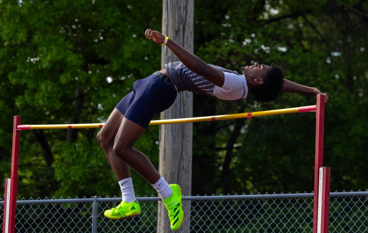 Senior Xavier Morrison flies over the high jump bar on Apr. 24. Morrison had scratched on his last attempt, and only had one jump left, so clearing on this attempt took pressure off his shoulder.

