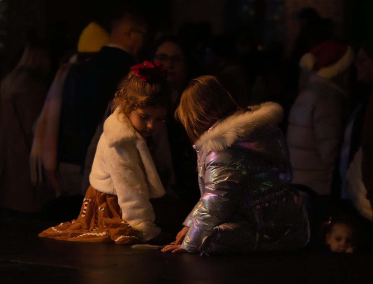 Following the sun’s disappearance beyond the horizon, children begin to make a performance on the stage for their families on Dec. 20. The families shared small giggles at the production the children put on.