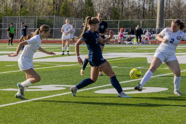 Taking a small step, sophomore Karsyn Black maneuvers her foot under the ball so that it would launch upwards on April 7. Right in front of her, however, stood another girl in her way ready to defend and refrain Central from coming close to their net.